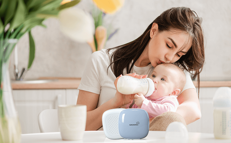 Mother feeding her baby with a bottle in a cozy kitchen, showcasing nurturing moments in parenting.