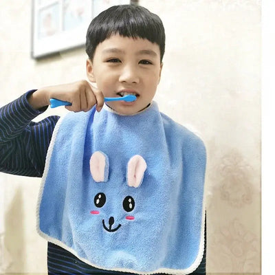 Smiling boy wearing a blue rabbit-themed baby bib while brushing his teeth, perfect for 3-8 year olds.