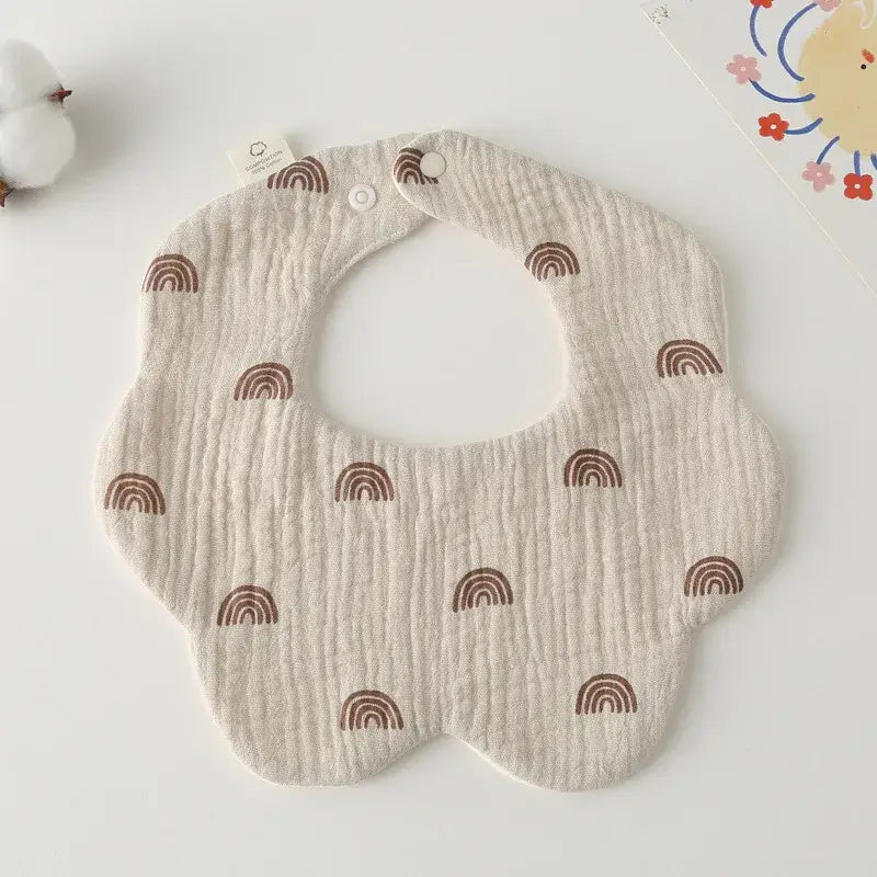 Cute cotton newborn bib with rainbow pattern for feeding and drooling, perfect baby accessory.