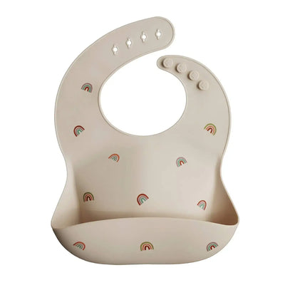 Soft silicone baby bib with cute rainbow print, waterproof and adjustable for toddlers, ideal for feeding.