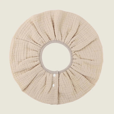 Absorbent infant burp cloth in soft beige cotton, designed for newborns, featuring a breathable four-layer gauze structure.