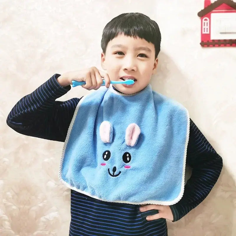Young boy wearing a cute blue cartoon bib while brushing his teeth, ideal for kids aged 3-8 years.