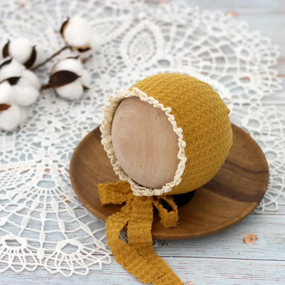 Cute newborn photography prop hat in waffle lace design, perfect for 0-6 months old baby girls, in soft mustard color.