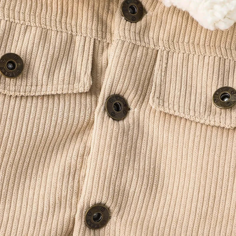 Close-up of the buttons and ribbed texture of a warm jacket for newborns made of cotton and polyester.