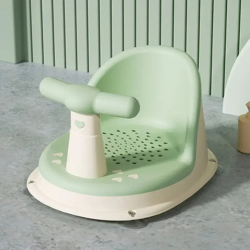 Baby bathtub seat in green, featuring suction cup design for safety, suitable for newborns and children 6-18 months.