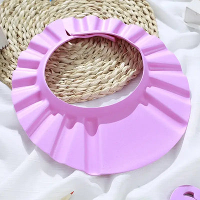Baby shower soft cap in pink, adjustable hair wash hat for kids to protect ears during bathing.