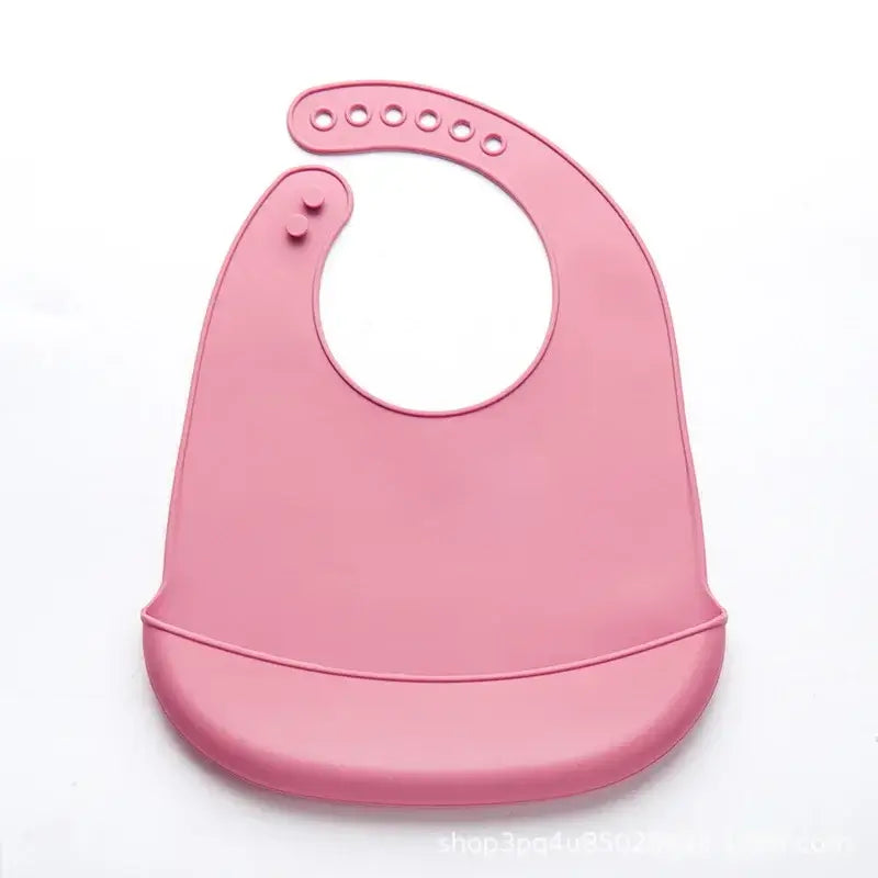 Soft pink adjustable waterproof silicone baby bib designed for drooling and feeding ease.