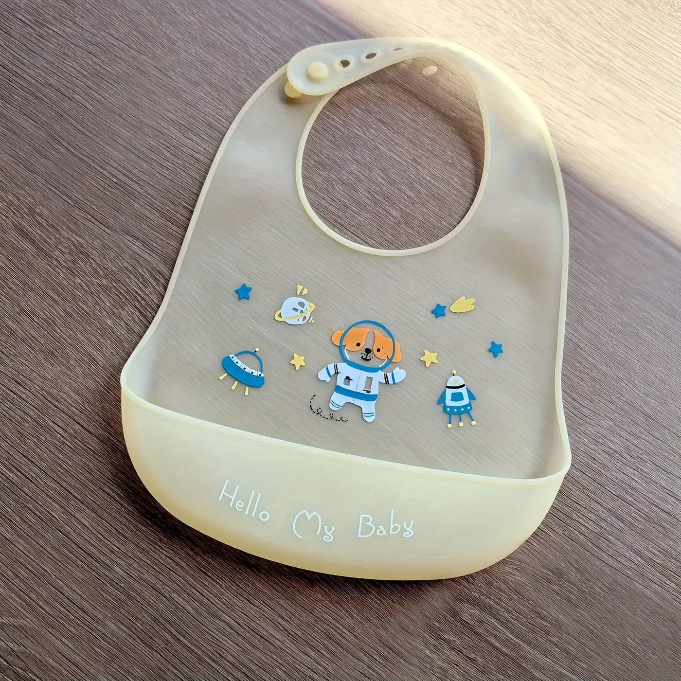 Cute cartoon printed silicone baby bib with dog and spaceship design, perfect for feeding kids aged 1-3 years.