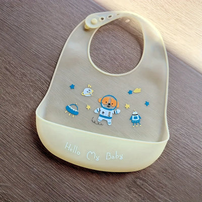 Cute cartoon printed silicone baby bib with dog and spaceship design, perfect for feeding kids aged 1-3 years.