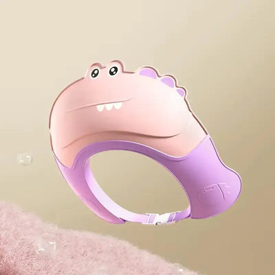 Cute baby shower cap with dinosaur design for kids, providing eye protection while washing hair during bath time.