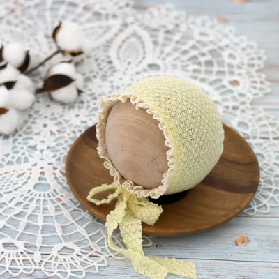 Cute newborn photography prop hat in soft yellow waffle lace, perfect for baby costumes and photo shoots.