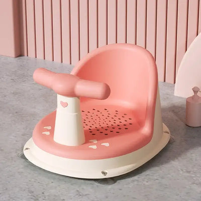 Baby bathtub seat in pink and white, featuring a suction cup base, designed for safe bathing of babies 6-18 months.
