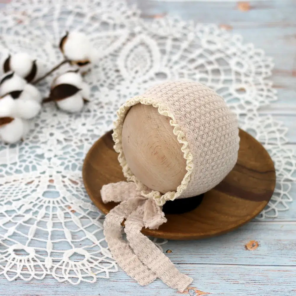 Baby photo prop cute newborn hat with lace tie on wooden bowl, perfect for photography sessions, unisex design.