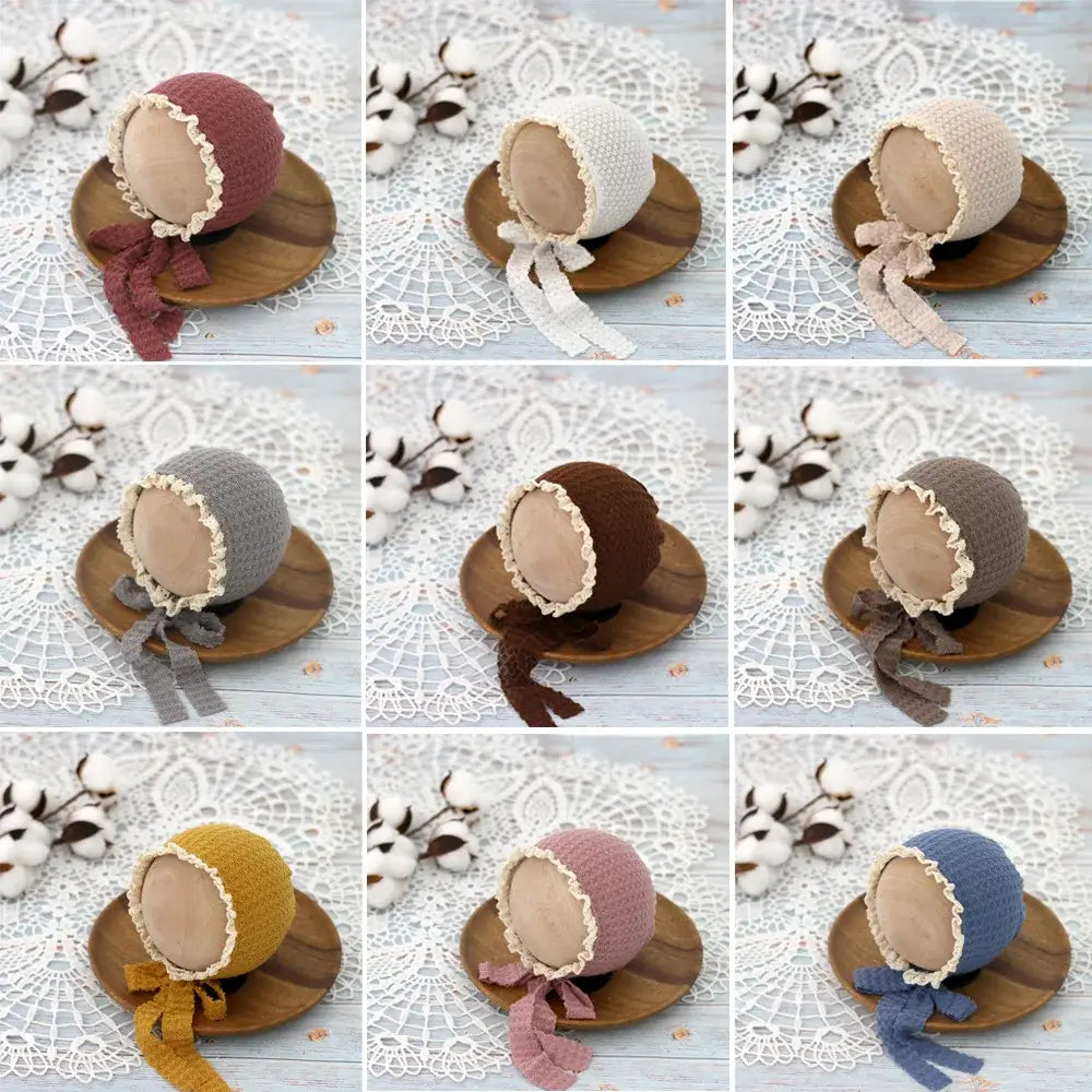Cute knitted baby hats with lace ties in various colors, perfect for newborn photography and stylish baby costumes.