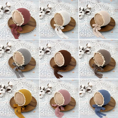 Cute knitted baby hats with lace ties in various colors, perfect for newborn photography and stylish baby costumes.
