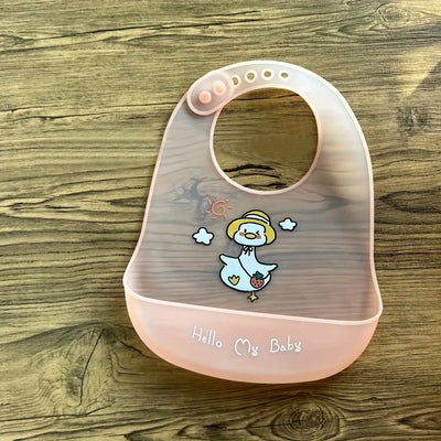 Cute pink silicone baby bib with cartoon duck print and adjustable snaps for easy feeding.