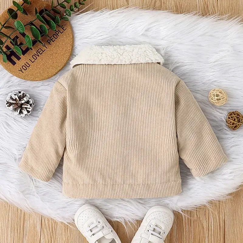 Back view of a warm beige corduroy jacket for newborn baby boy, featuring a cozy collar and perfect for winter.