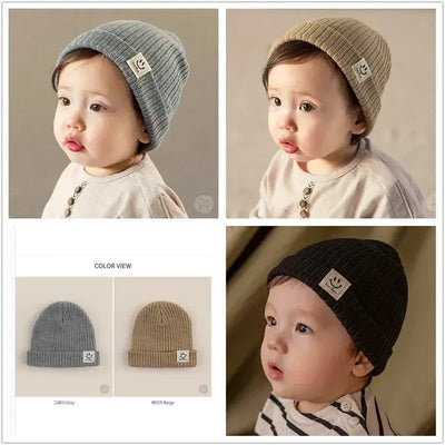 Baby knitted hats in gray and beige, showcasing a happy face patch, perfect for boys and girls during winter.